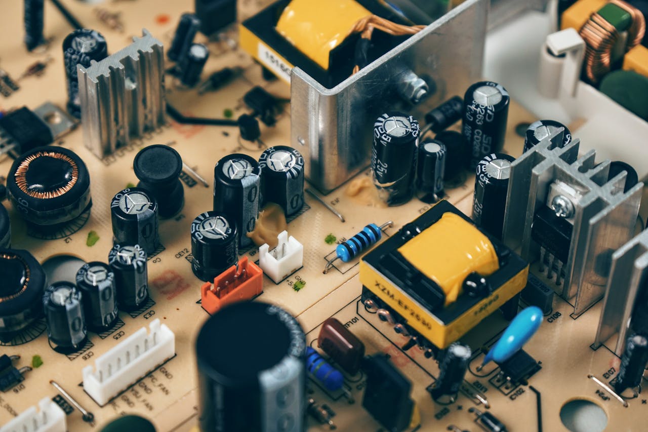 why-choose-us Detailed shot of capacitors and resistors on a circuit board, showcasing modern technology.
