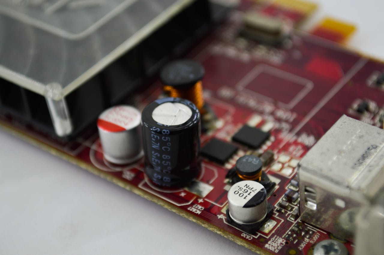 about-01 Detailed macro shot of a circuit board highlighting capacitors, chips, and circuits.